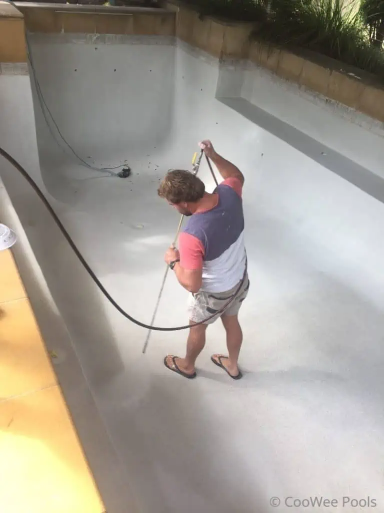 washing new pool interior