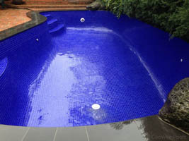 fully tiled pool in dark blue