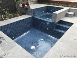 fully tiled pool including spa