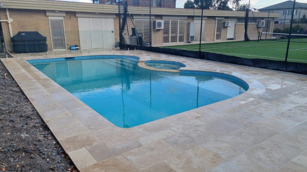 Full renovation of pool. Travertine coping, Moolooabah tiles sky blue with dark blue speck and sparkle.