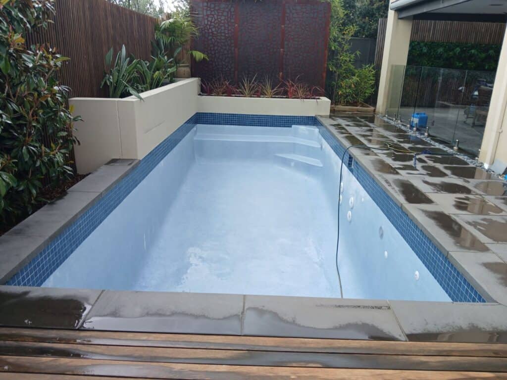 pool interior New waterline tile, new mid blue interior with blue glass